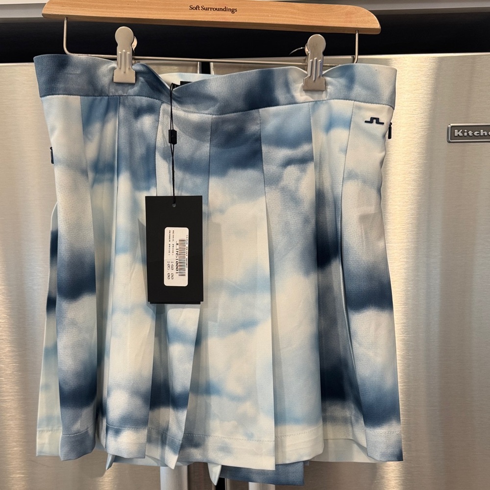 J.Lindeberg Adina Printed Golf Skirt in a blue and white cloud pattern. L